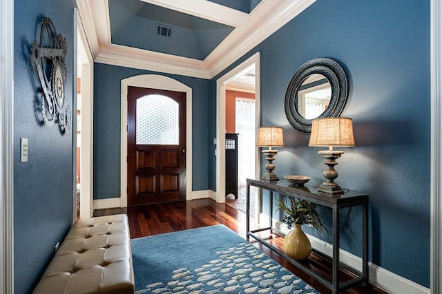 entryway with dark wood-type flooring and ornamental molding