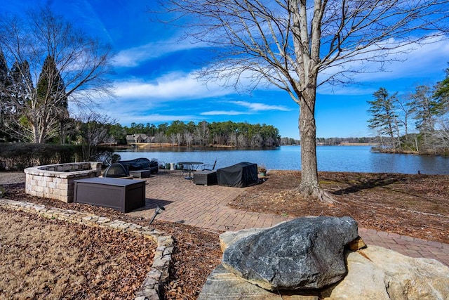 view of patio / terrace featuring a water view and an outdoor fire pit