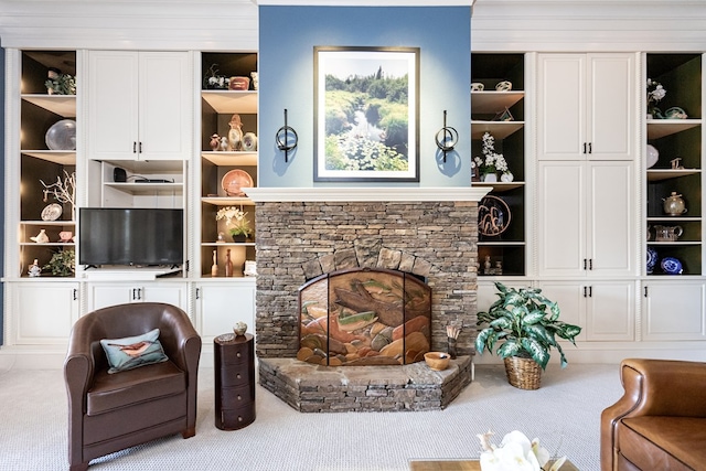 living room featuring light carpet, a fireplace, and built in features