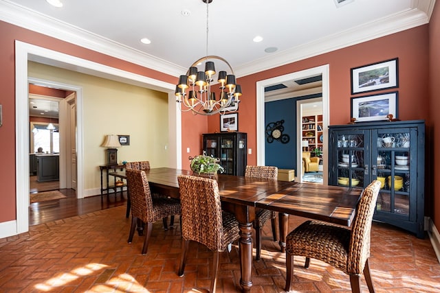 dining space with an inviting chandelier and ornamental molding