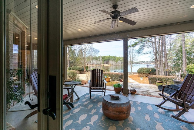 sunroom featuring a water view, ceiling fan, and wooden ceiling