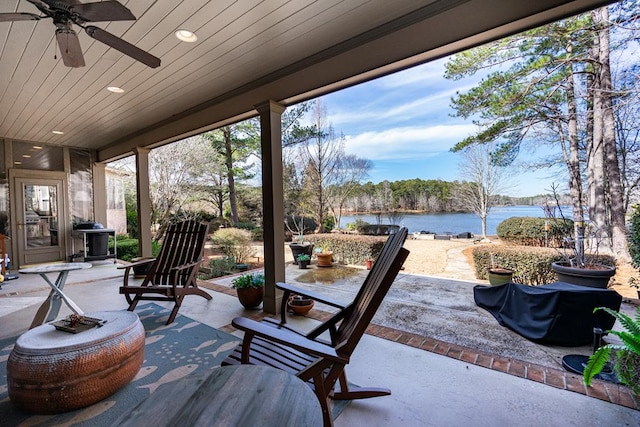 view of patio featuring a water view and ceiling fan