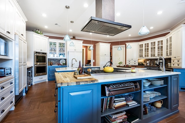 kitchen featuring extractor fan, blue cabinets, white cabinetry, hanging light fixtures, and a large island