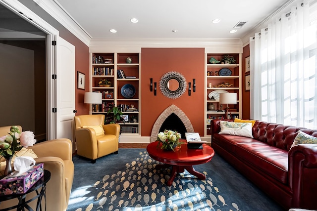 living room with ornamental molding, a fireplace, and built in features