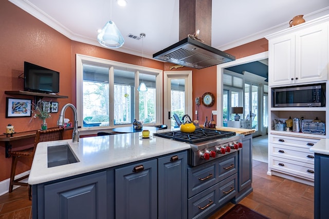 kitchen with appliances with stainless steel finishes, island range hood, decorative light fixtures, white cabinets, and crown molding