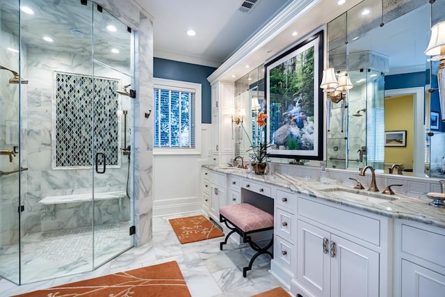 bathroom with crown molding, vanity, and a shower with door