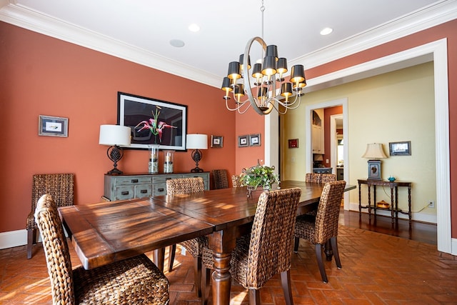 dining space with ornamental molding and an inviting chandelier