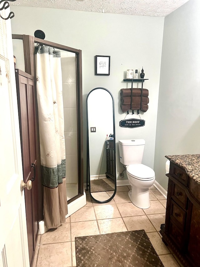4212 Canady St, Columbus, GA 31909 - bathroom featuring a shower stall, toilet, vanity, tile patterned flooring, and a textured ceiling