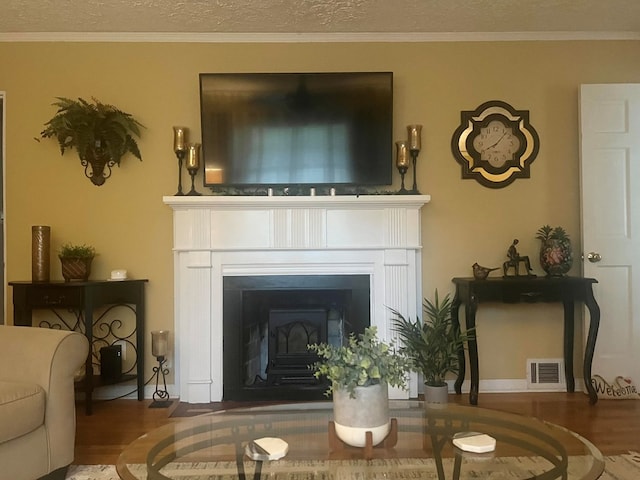 4212 Canady St, Columbus, GA 31909 - living area with a fireplace, wood finished floors, ornamental molding, and a textured ceiling