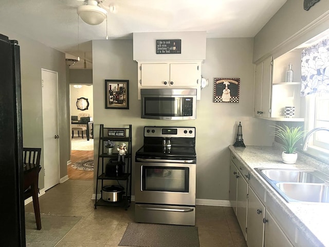 4212 Canady St, Columbus, GA 31909 - kitchen featuring stainless steel appliances, a sink, open shelves, and dark tile patterned floors