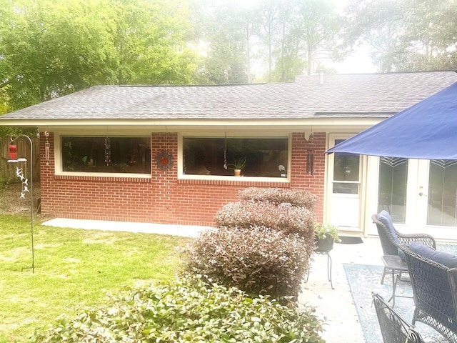 4212 Canady St, Columbus, GA 31909 - view of home's exterior with roof with shingles, brick siding, and a patio area