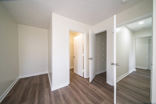 interior space featuring dark hardwood / wood-style floors and a textured ceiling