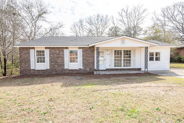 single story home with covered porch and a front lawn