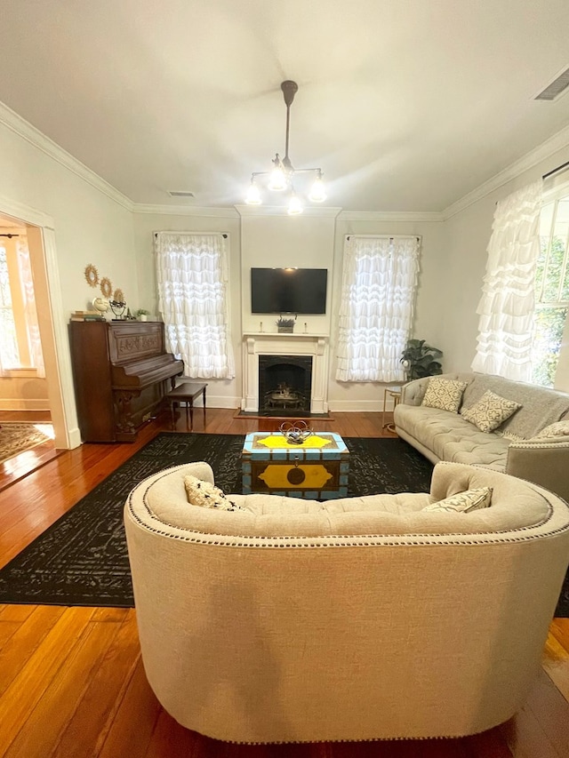 living room with ornamental molding and hardwood / wood-style floors