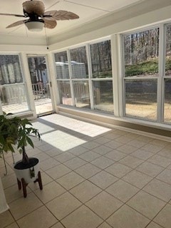 unfurnished sunroom with ceiling fan