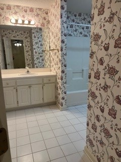 bathroom featuring vanity, tile patterned floors, and shower / tub combination