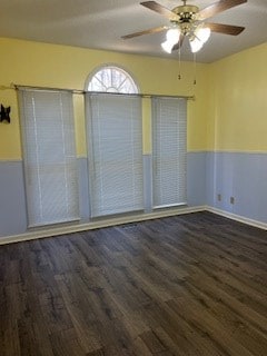 spare room with ceiling fan and dark hardwood / wood-style flooring