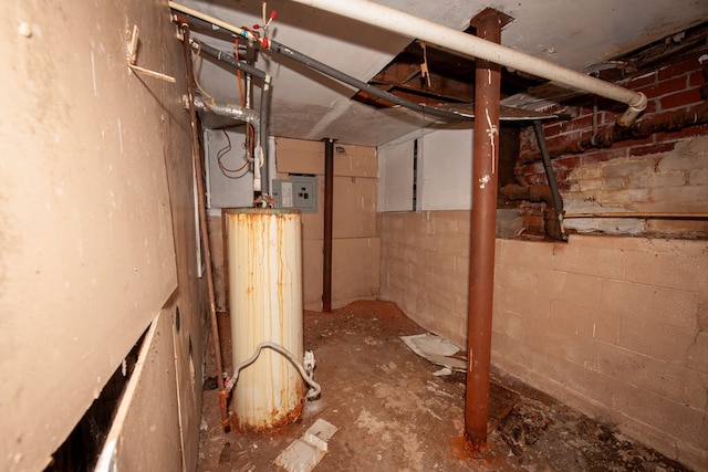 unfinished basement featuring concrete block wall and electric panel