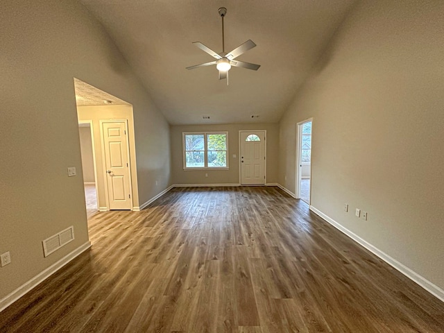 unfurnished living room with ceiling fan, high vaulted ceiling, and dark hardwood / wood-style floors