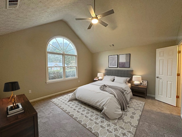 carpeted bedroom with ceiling fan, a textured ceiling, and vaulted ceiling