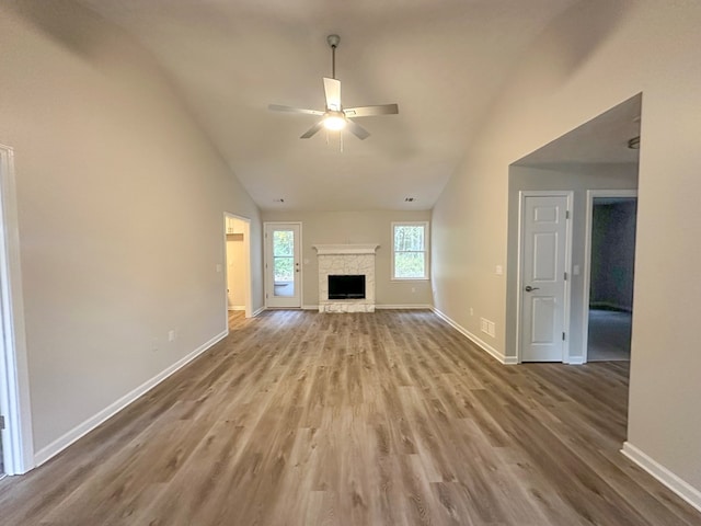 unfurnished living room with ceiling fan, light hardwood / wood-style floors, and vaulted ceiling