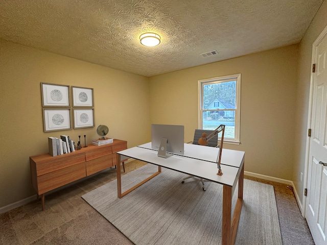 office with carpet and a textured ceiling