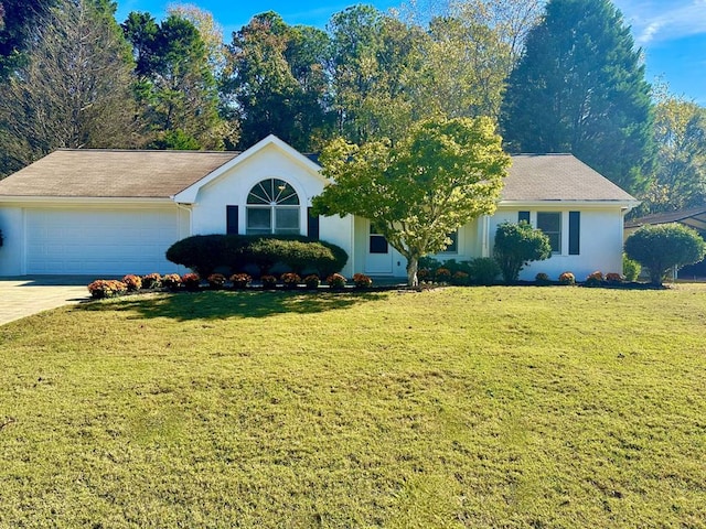 view of front of home with a front lawn and a garage