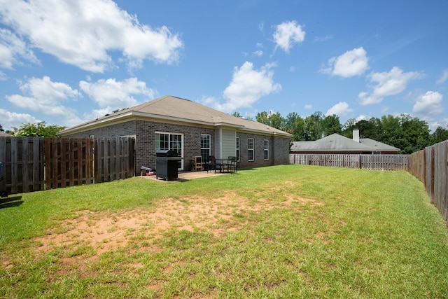 6074 White Pine Dr, Midland, GA 31820 - rear view of property featuring brick siding, a patio, and a fenced backyard