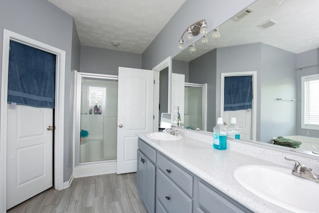 6074 White Pine Dr, Midland, GA 31820 - full bathroom featuring a shower stall, wood finished floors, double vanity, and a bath