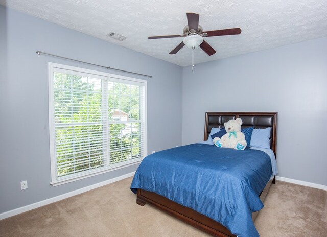 6074 White Pine Dr, Midland, GA 31820 - bedroom featuring carpet floors, a textured ceiling, and a ceiling fan