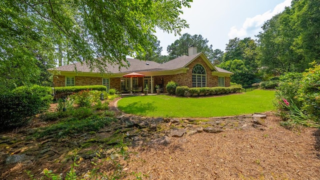 9011 Travelers Way, Midland, GA 31820 - rear view of property featuring a chimney, a yard, and brick siding