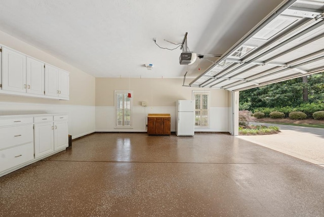 9011 Travelers Way, Midland, GA 31820 - garage featuring freestanding refrigerator, baseboards, and a garage door opener