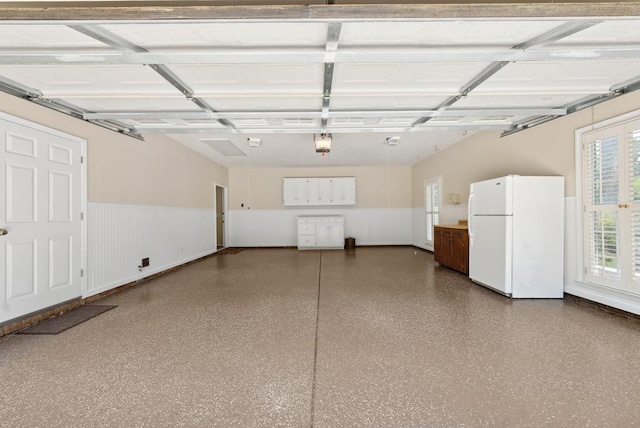 9011 Travelers Way, Midland, GA 31820 - garage with freestanding refrigerator, a wainscoted wall, and a garage door opener