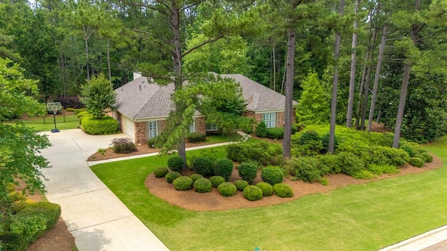 9011 Travelers Way, Midland, GA 31820 - view of front of home featuring driveway, a front lawn, an attached garage, and brick siding