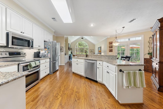 9011 Travelers Way, Midland, GA 31820 - kitchen with appliances with stainless steel finishes, white cabinetry, light wood-type flooring, tasteful backsplash, and ornamental molding