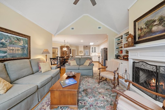9011 Travelers Way, Midland, GA 31820 - living room featuring ceiling fan, a warm lit fireplace, lofted ceiling, crown molding, and a chandelier