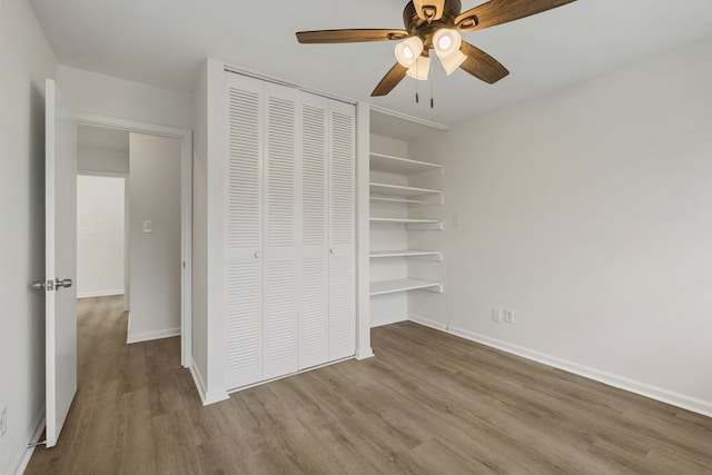 unfurnished bedroom with a closet, light wood-style flooring, and baseboards