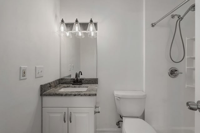 bathroom with toilet, walk in shower, and vanity