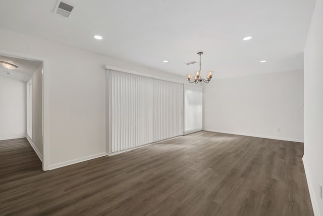 unfurnished room featuring visible vents, baseboards, recessed lighting, dark wood-style flooring, and a chandelier