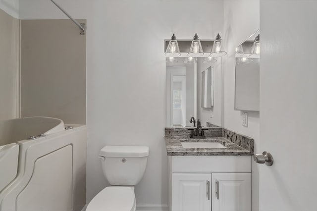 full bath featuring vanity, toilet, and a washtub