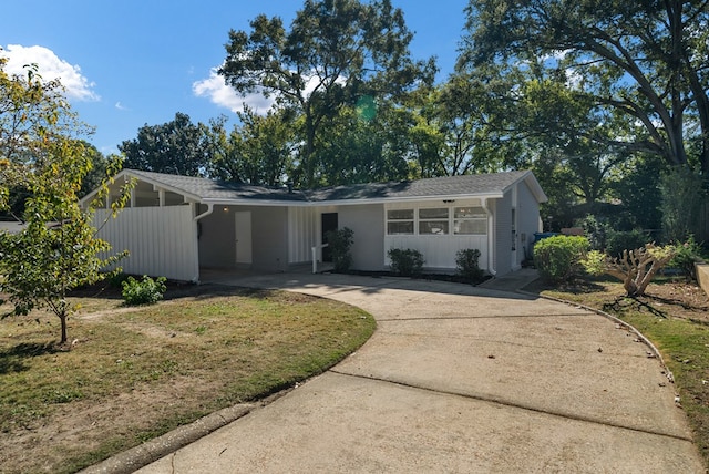 ranch-style home with a front lawn and a carport