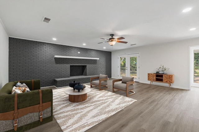 living area featuring recessed lighting, visible vents, plenty of natural light, and wood finished floors