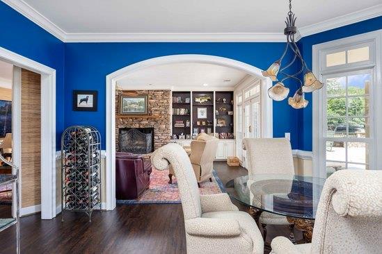 219 Broken Rock Rd, Hamilton, GA 31811 - dining area with dark wood-type flooring, arched walkways, crown molding, a fireplace, and built in shelves