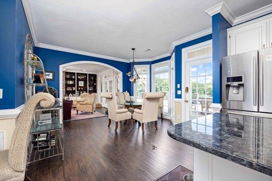 219 Broken Rock Rd, Hamilton, GA 31811 - dining space featuring wood finished floors, arched walkways, crown molding, and a chandelier