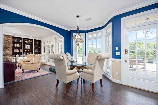 219 Broken Rock Rd, Hamilton, GA 31811 - dining area with wood finished floors, crown molding, arched walkways, and built in shelves