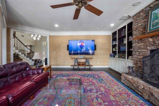 219 Broken Rock Rd, Hamilton, GA 31811 - living area featuring crown molding, stairway, a ceiling fan, a stone fireplace, and recessed lighting