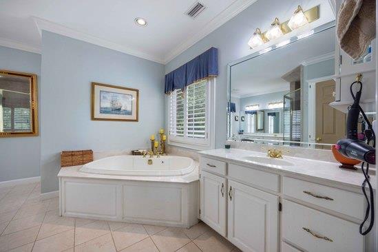 219 Broken Rock Rd, Hamilton, GA 31811 - full bath with ornamental molding, a garden tub, vanity, tile patterned flooring, and a shower with shower door