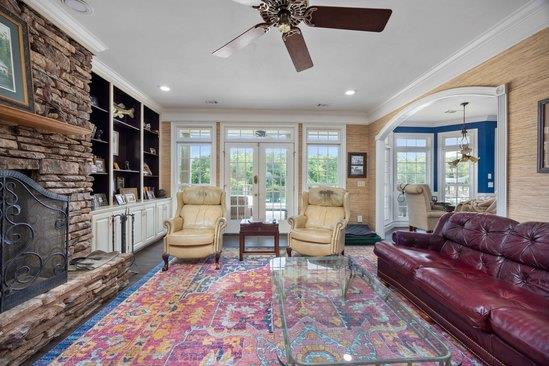 219 Broken Rock Rd, Hamilton, GA 31811 - living room with crown molding, a stone fireplace, ceiling fan, french doors, and recessed lighting