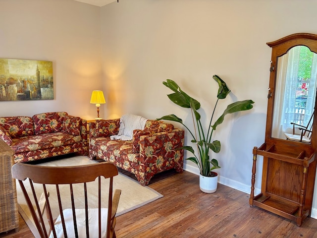 living room featuring wood finished floors and baseboards
