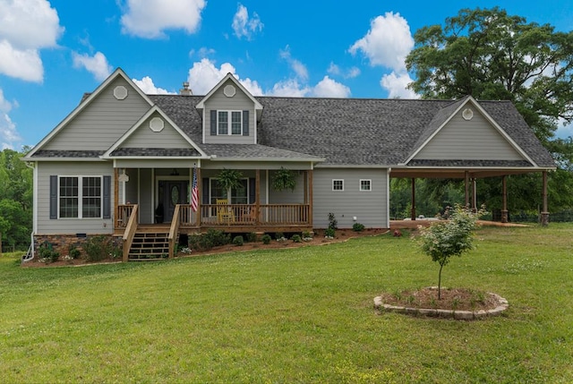 craftsman inspired home featuring covered porch, roof with shingles, and a front yard